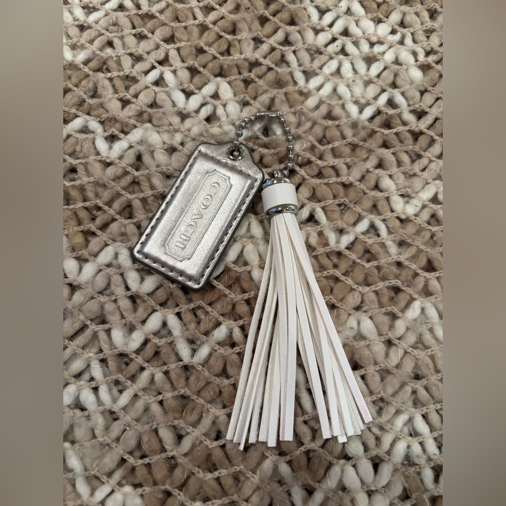 Coach Metallic Silver leather and White Tassel Keychain